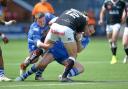 Jono Smith tries to get to grips with Widnes' Chris Dean