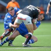 Jono Smith tries to get to grips with Widnes' Chris Dean