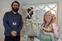 Jack Monopoli, recruitment coordinator at Westmorland Homecare's South Lakeland branch, presents flowers to Helen Manning in recognition of her actions