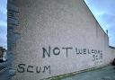 Graffiti on property in Millom saying 'not welcome scum.'