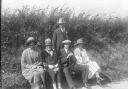 Roadside bench of three women and two men, dressed in their Sunday Best in 1924.