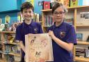 South Walney Junior School pupils Max and Mary with the third edition of Lost Words of Walney, which is a collection of poems and watercolours celebrating the unique wildlife and plants of Walney Island.