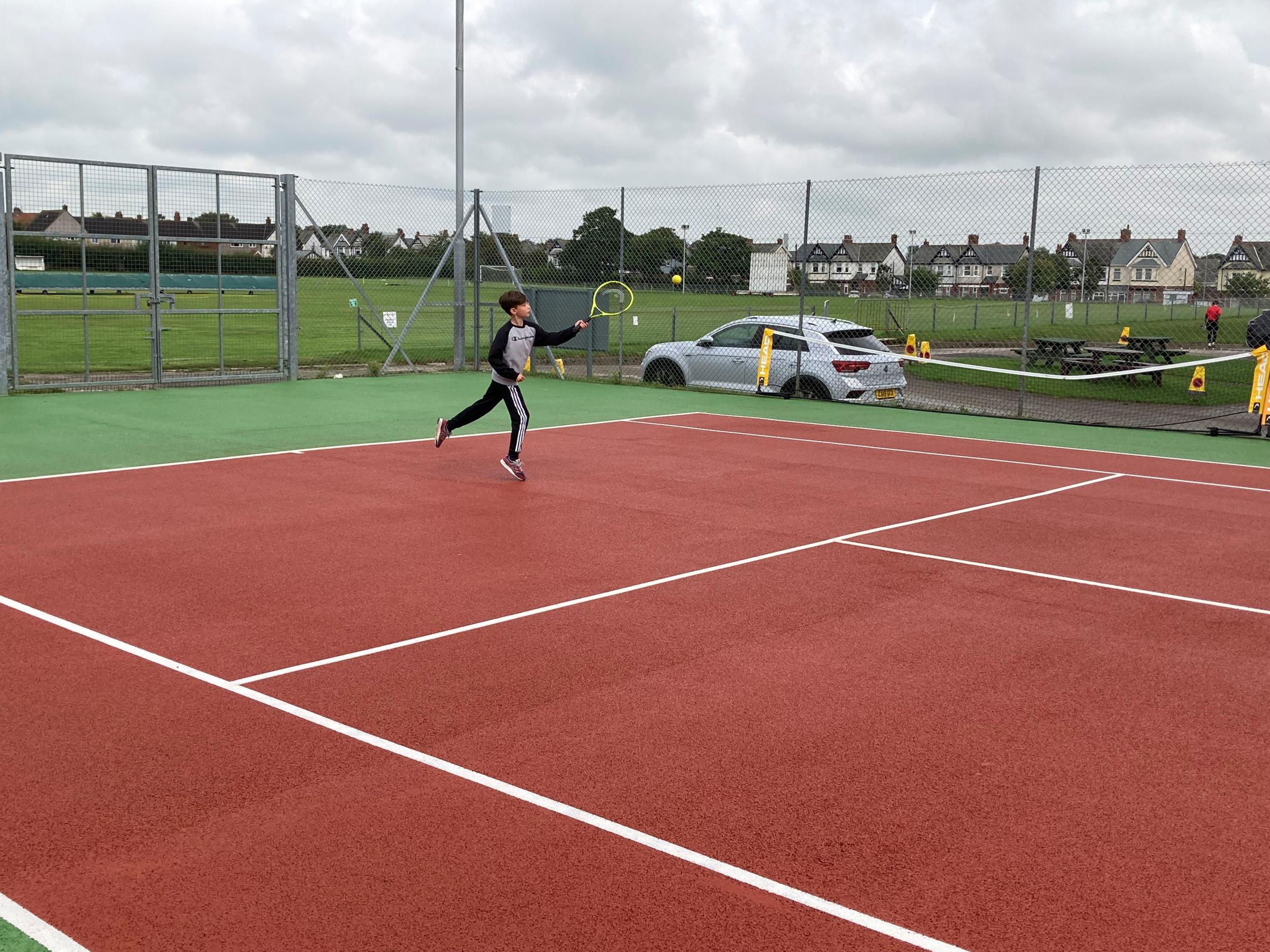 AIR: Hughie Ward playing the approach shot on Hawcoat Parks newly opened tennis courts