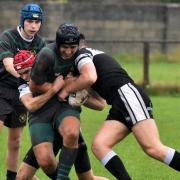 SURROUNDED: Two Saddleworth players combine well