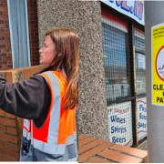 PATROL: A 'No Dog Fouling' sticker being placed on a lamp post