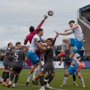 Newport’s Nick Townsend punches clear from Barrow’s Rory Feely and Niall Canavan at Holker Street on Saturday.  Pictures: Ian Allington | MI News)