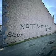 Graffiti on property in Millom saying 'not welcome scum.'