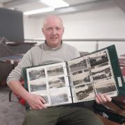 1818 Auctioneers Assistant Manager Simon Thompson with postcard collection