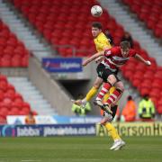 Barrow's Rory Feely challenges for a header with Joe Ironside  during the Sky Bet League 2 match between Doncaster Rovers and Barrow at the Keepmoat Stadium, Doncaster on Saturday 20th April 2024. (Photo: Mark Fletcher | MI News).
