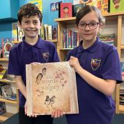 South Walney Junior School pupils Max and Mary with the third edition of Lost Words of Walney, which is a collection of poems and watercolours celebrating the unique wildlife and plants of Walney Island.
