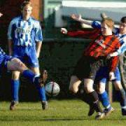 CONCERN: Prolific striker Carl Waters (second right) suffered a bad injury during Millom’s draw at Crooklands Casuals