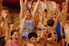 CHEERS Arms are raised at the climax of a close race at the swimming gala held in March 2002.