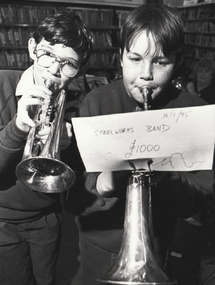Barrow Steelworks Band members Gareth Hillbeck and Chris Jackson celebrating the band receiving £1,000 from Barrows Neighbourhood Forum at the bands rehearsal at Barrow Library in 1995