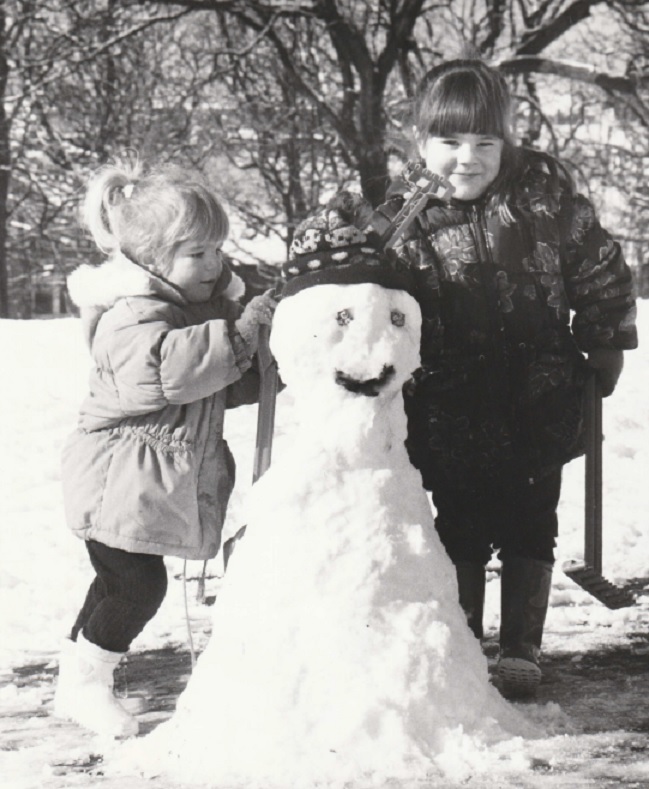 BUILD: Two-year-old Victoria donates her hat and four-year-old sister Rachael provides Opal Fruits as eyes for their snowman in Barrow Park