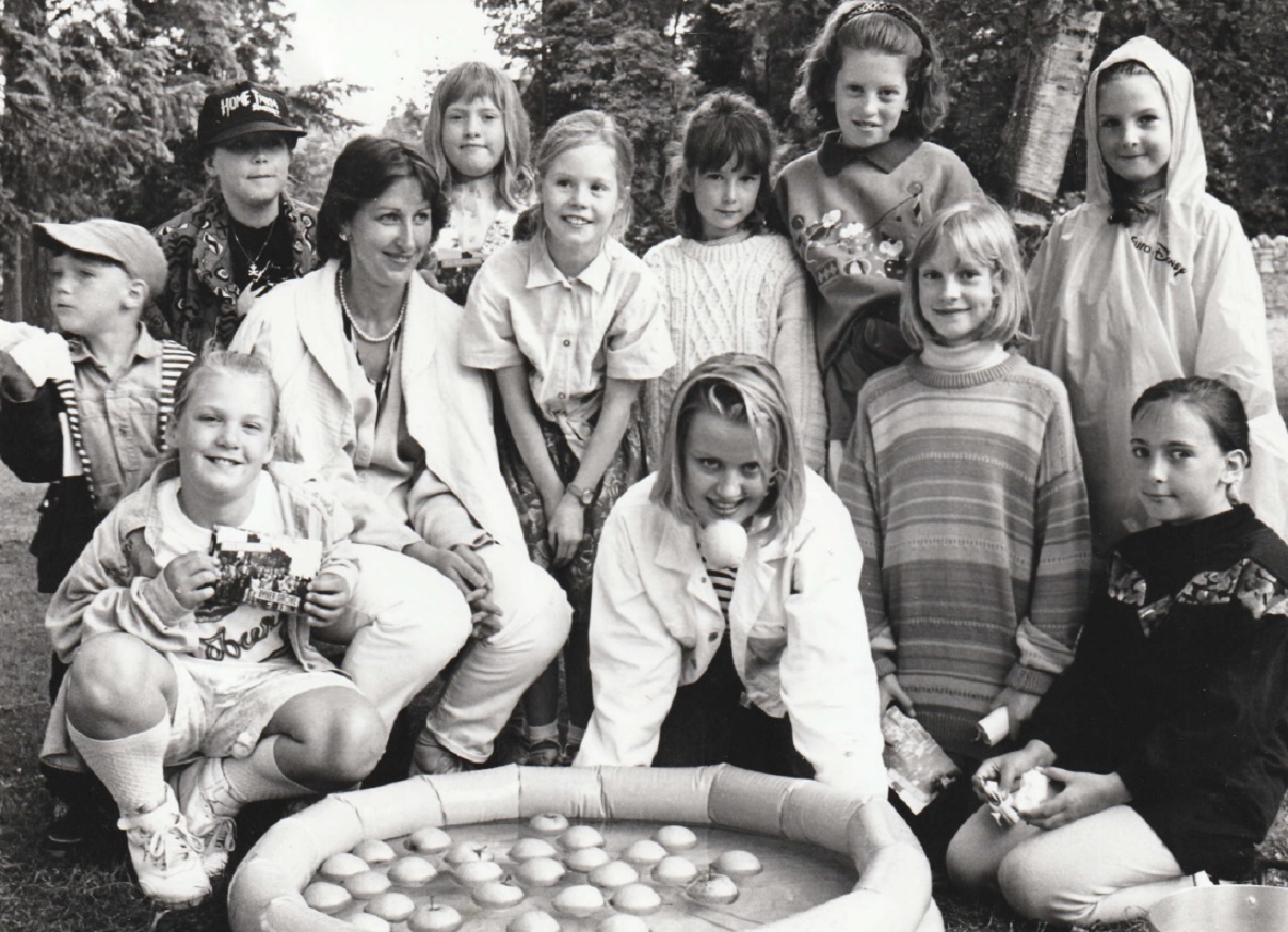 ENTERTAINMENT: Michelle Charles, from BBC TVs Byker Grove, opened the Grange-over-Sands Junior Schools summer fair in 1993. She is pictured at the duck apple stall run by Marion Turner with some of the pupils who attended