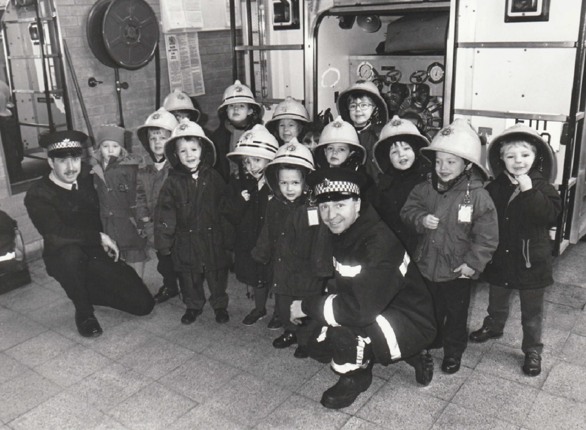 Dalton firefighters Roy Coward (left) and Dave Bell show Chapel Street Infants School pupils inside their fire station in 1995