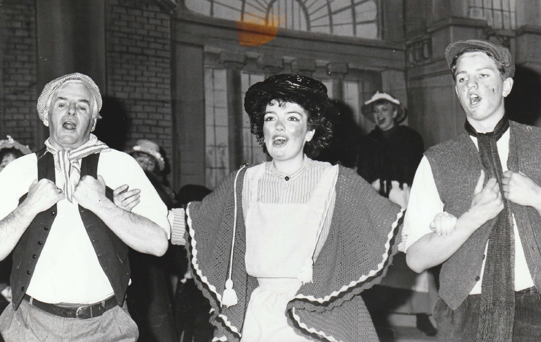 SING: Eliza (Margot Lewis) and supporting members of the gentlemen’s chorus in a scene from My Fair Lady in 1988
