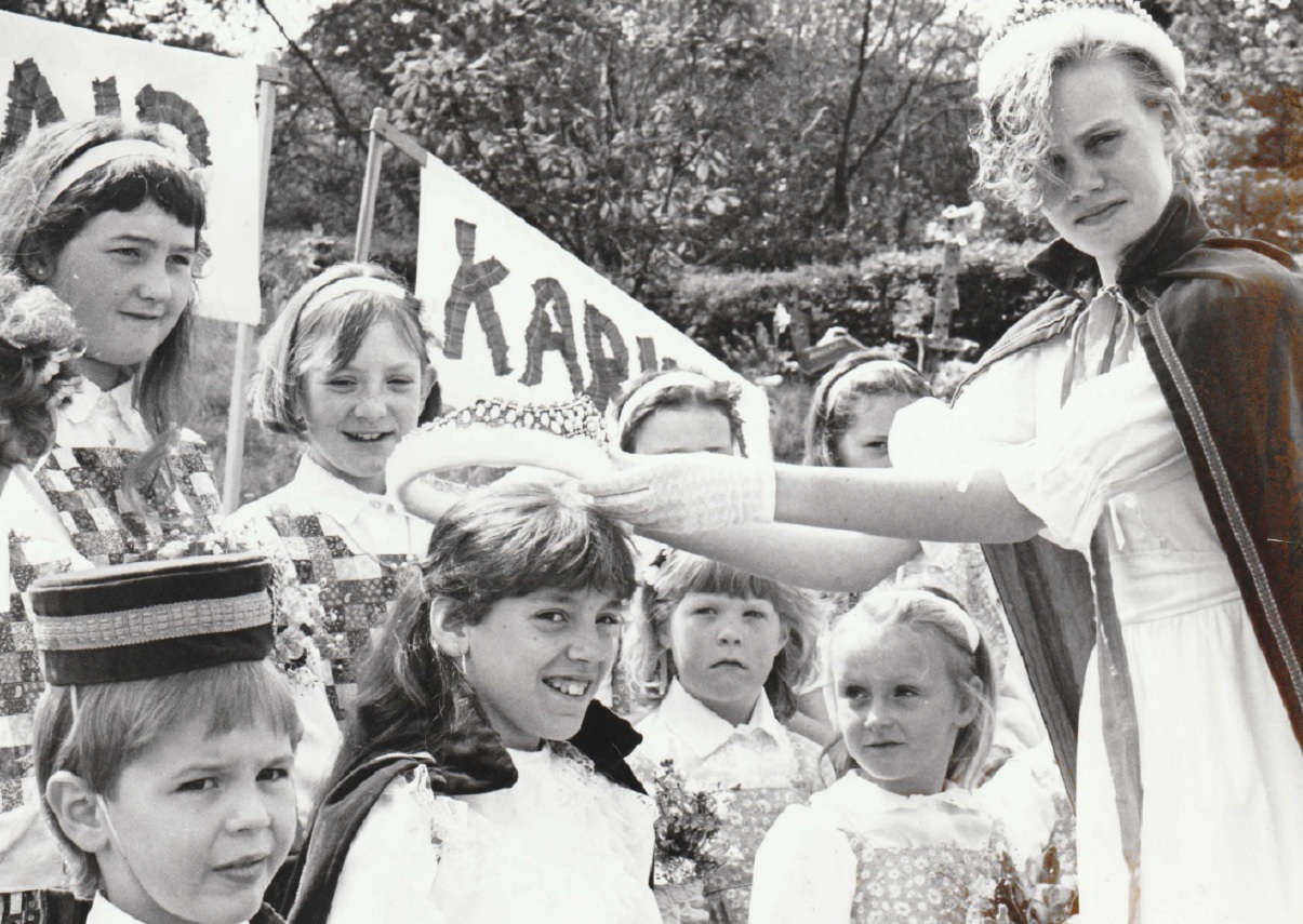 RETIRE: Retiring Queen Katrina Black crowns that year’s queen Clair Louise Humphery, 11, at the May Day celebrations at Penny Bridge School in 1989