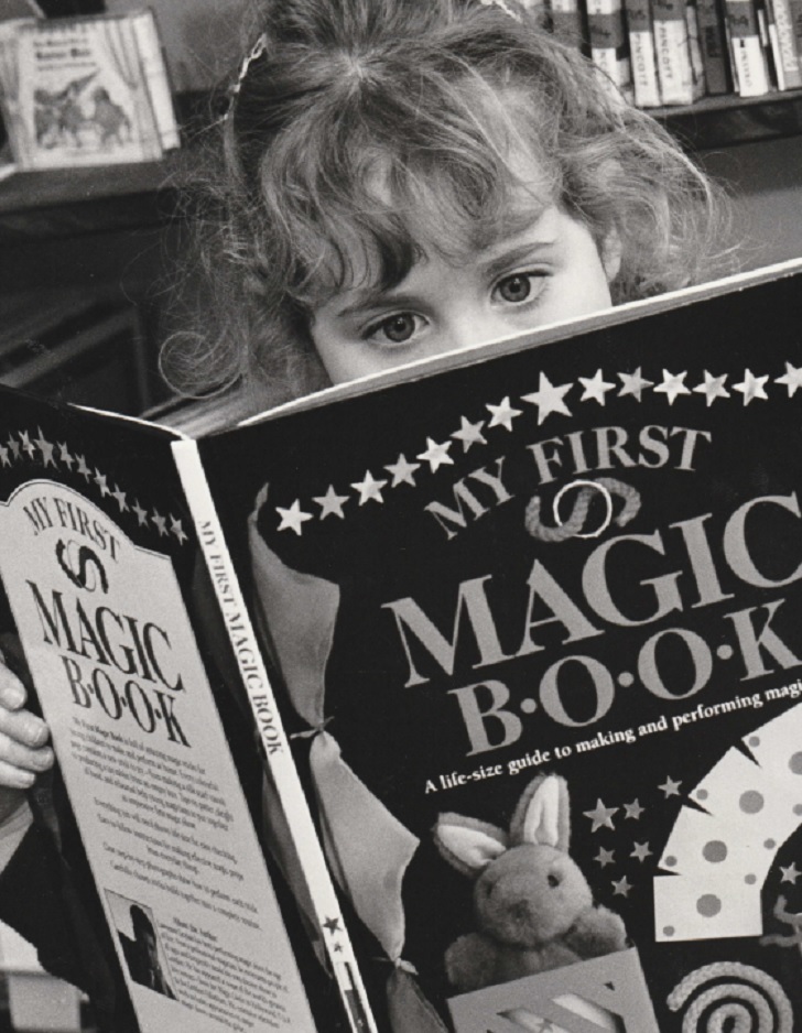 SCHOOL: Alex Emms, five, engrossed in a book about magic during Penny Bridge School’s annual book week in 1994