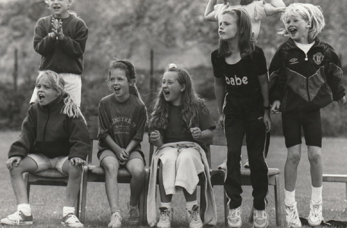 Pupils cheer on competitors at St Pius X School sports day in 1995