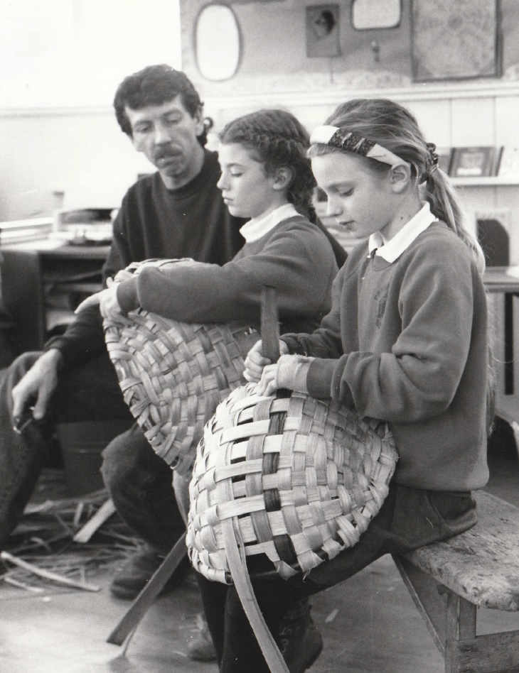 CRAFT: Swill maker Owen Jones visited Pennington C of E School in 1996. He is pictured helping Joanne, nine, (left) and Hannah, nine, to make traditional oak swill baskets