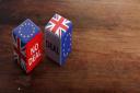 Brexit, deal or no deal concept. United Kingdom and European Union flags on dice, wooden background, banner, copy space. 3d illustration.