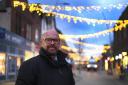 LIGHTING UP: Barrow BID Manager, Colin Garnett with new Christmas lights in Barrow town centre by local company Optech