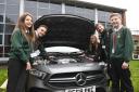 PETROL HEADS: Ben Charlotte Lucy and Kai from Millom school are shown round a car by Ben Tothill from Mercedes Benz South Lakes