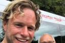 SMILES: Ollie Murs with driver-guide Gerry. Picture: The Mountain Goat Tour Company