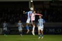 Hartlepool’s Bogle contests a header with Connor Brown. Pictures: Mark Fletcher | MI News