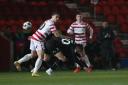 Ged Garner battles with Doncaster Rovers’ Tommy Rowe. Pictures: Mark Fletcher | MI News