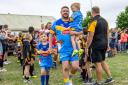 Family matters: Graham Shaw walks out with sons Bobby (in his arms) and Harry for the Hindpool Tigers v RL All Stars match STEVE MILLER