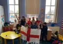The kids made their own England flag to wave during the event