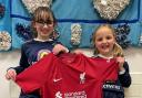 Members of the St Mary's Catholic School girls' football club show off the Liverpool shirt