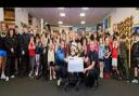Barrow Amateur Boxing Club (Barrow ABC) pictured with Mia and her family holding the cheque
