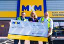 The MKM team with giant £2k cheque raised for St Mary's Hospice