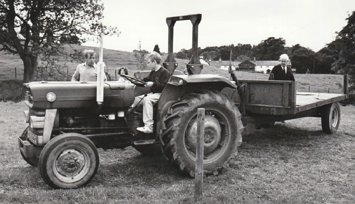 TRACTOR: Roger Benton, 13, on the tractor driving course, watched by father Ian
