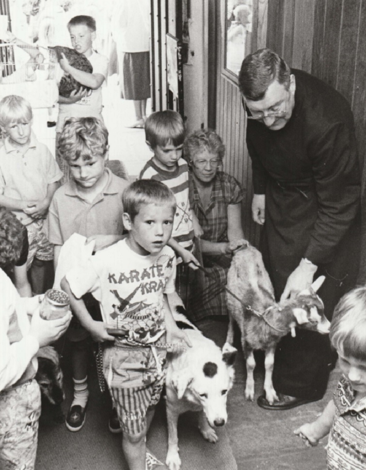 PETS: The Rector, the Rev Peter Humpleby, welcomes Aldingham children and their pets into St Cuthbert’s Church for a special pets service in 1991
