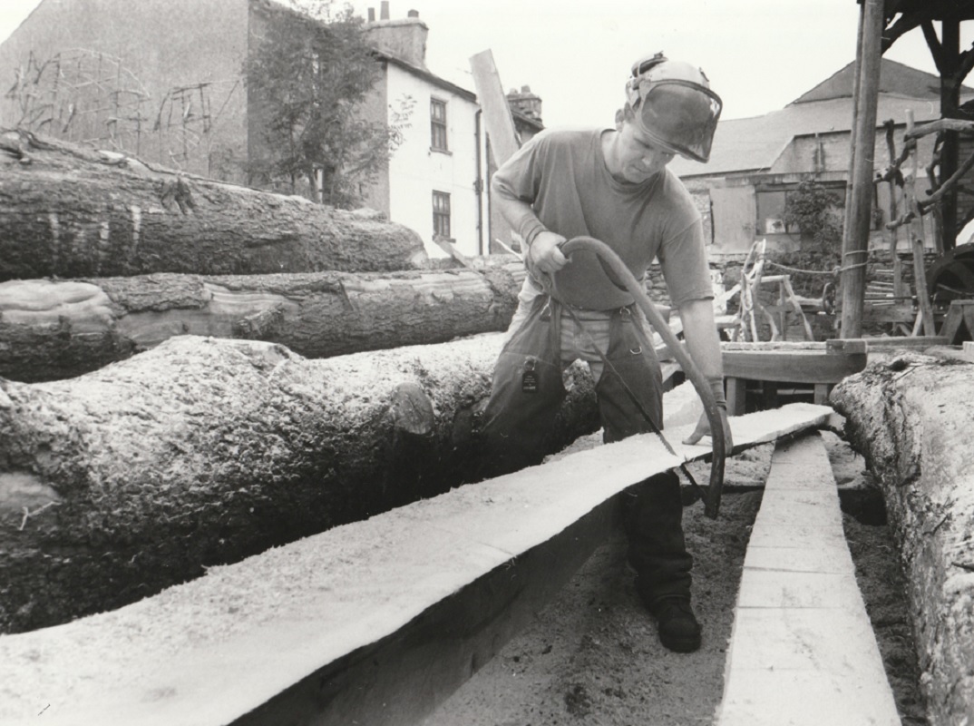 STATE: Project manager Chris Coates trims the beams of the cruck barn being constructed at Welfare State International’s Ulverston HQ in 1995