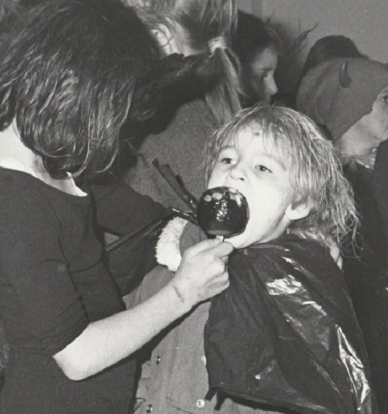 FRIENDS: A youngster gets a bite of toffee apple from a pal at the Greengate Street Residents’ Association Hallowe’en procession in 1994