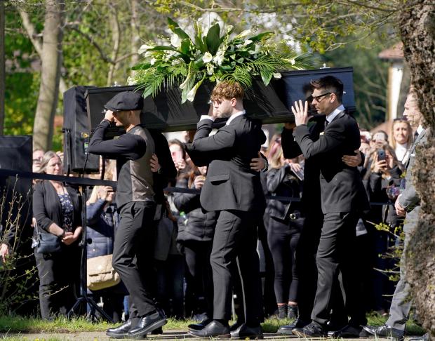 The Mail: Max George (left) and Jay McGuiness of The Wanted (centre) carry the coffin at the funeral of their bandmate Tom Parker. (PA)