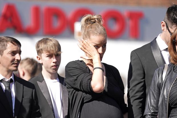 The Mail: Mourners watch as the coffin of The Wanted star Tom Parker is carried ahead of his funeral. (PA)
