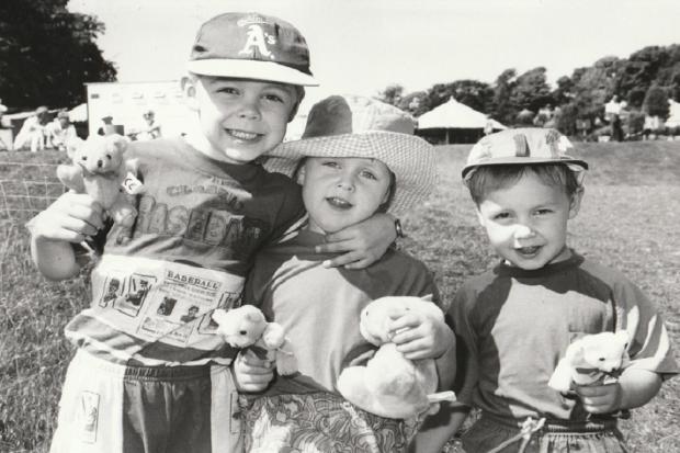 Liam, six, Kelsey, three, and Nathan, three, Tollady, of Lakeside, with their prizes from a stall at North Lonsdale Show in 1995
