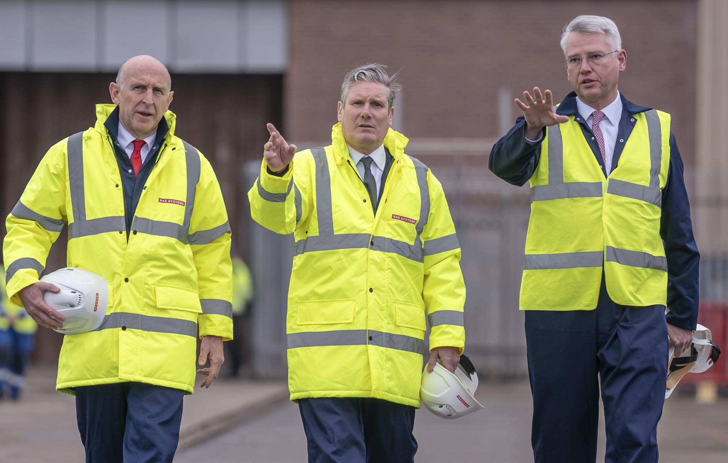 Labour Party leader Sir Keir Starmer with shadow defence secretary John Healey (left) and CEO of BAE Systems (right), during a campaign visit to BAE Systems in Barrow-in-Furness, Cumbria. The Labour leader has said the UKs nuclear deterrent is the