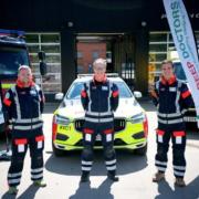 BEEP: Three volunteer doctors, with Theo Weston MBE, Chairman in the centre in front of XC emergency vehicle.