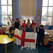 The kids made their own England flag to wave during the event