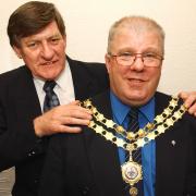 Ulverston mayor Councillor John Birkett (left) passes on the mayoral chain of office to Councillor Dave Miller for his fourth term as the Ulverston mayor in 2005