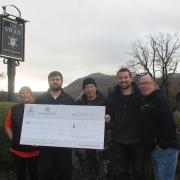 The Swan, Grasmere general managers Nellie Buxton and Nigel Brown presenting the RAOB Lamb and Lion fund with a Give Inn Back donation