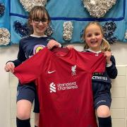 Members of the St Mary's Catholic School girls' football club show off the Liverpool shirt