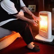 EMBARGOED TO 0001 MONDAY APRIL 17.File photo dated 19/11/14 of an elderly lady with her electric fire on at home, as one in 25 older people living alone in some areas of England and Wales have no central heating, new analysis suggests. PA Photo. Issue